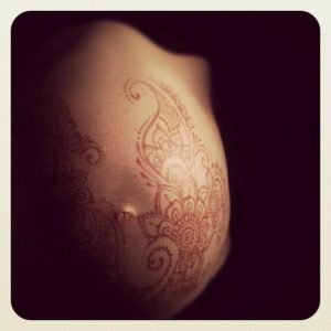 Pregnant belly with a henna tattoo.